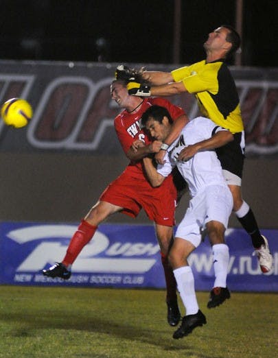 Lobo Zach Tierney, left, and goalkeeper Eric Staver defend against Akron's Matt Tutich during the Lobos' 1-0 win at the UNM Soccer Complex on Friday.