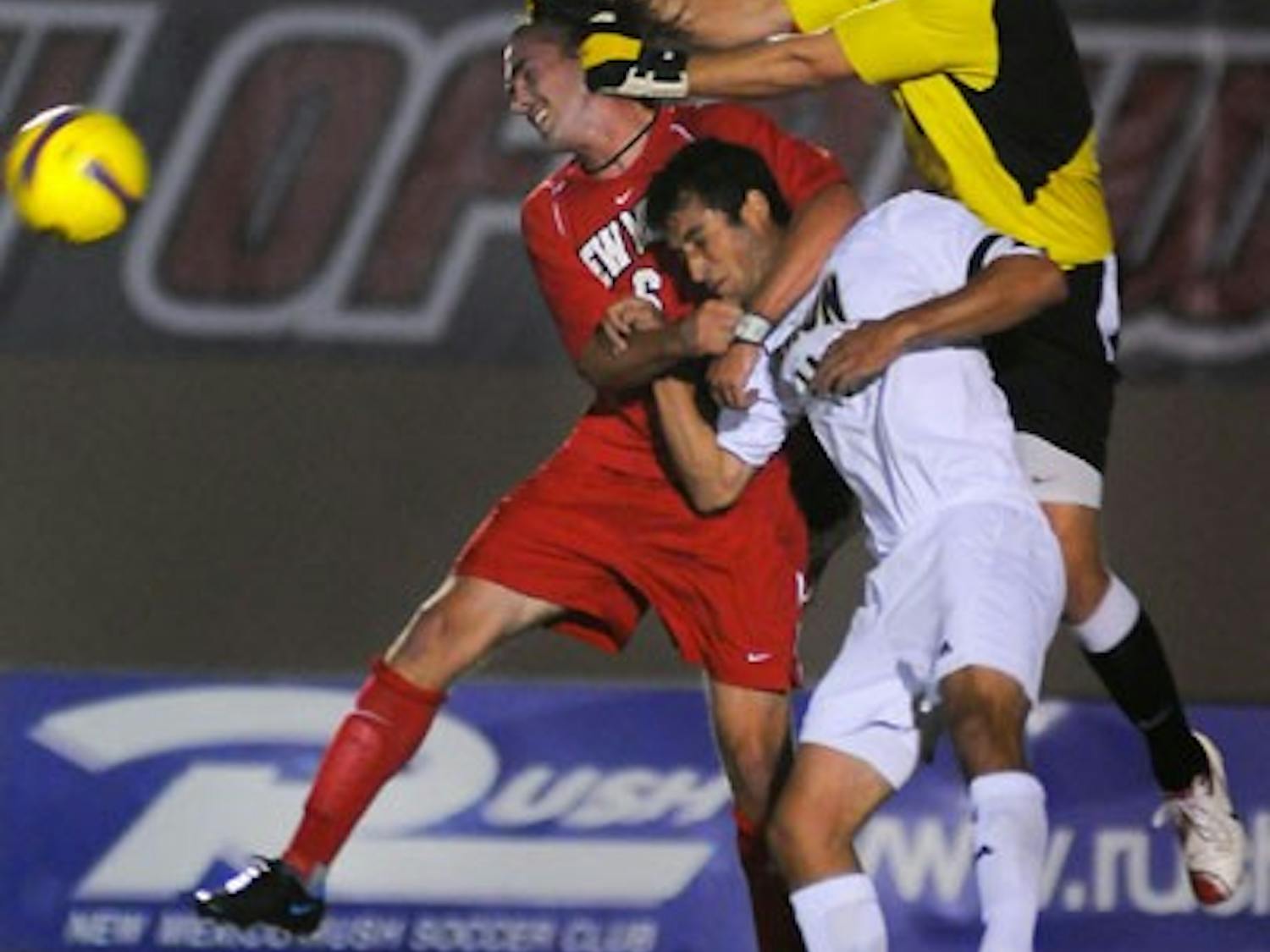 Lobo Zach Tierney, left, and goalkeeper Eric Staver defend against Akron's Matt Tutich during the Lobos' 1-0 win at the UNM Soccer Complex on Friday.