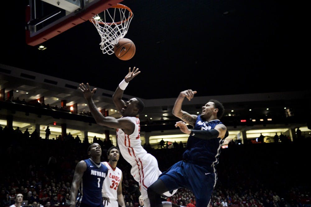 Sophomore guard/forward Sam Logwood leaps through Nevada's defense as he attempts a layup at WisePies Arena Wednesday night. The Lobos beat the Wolf Pack 88-76.