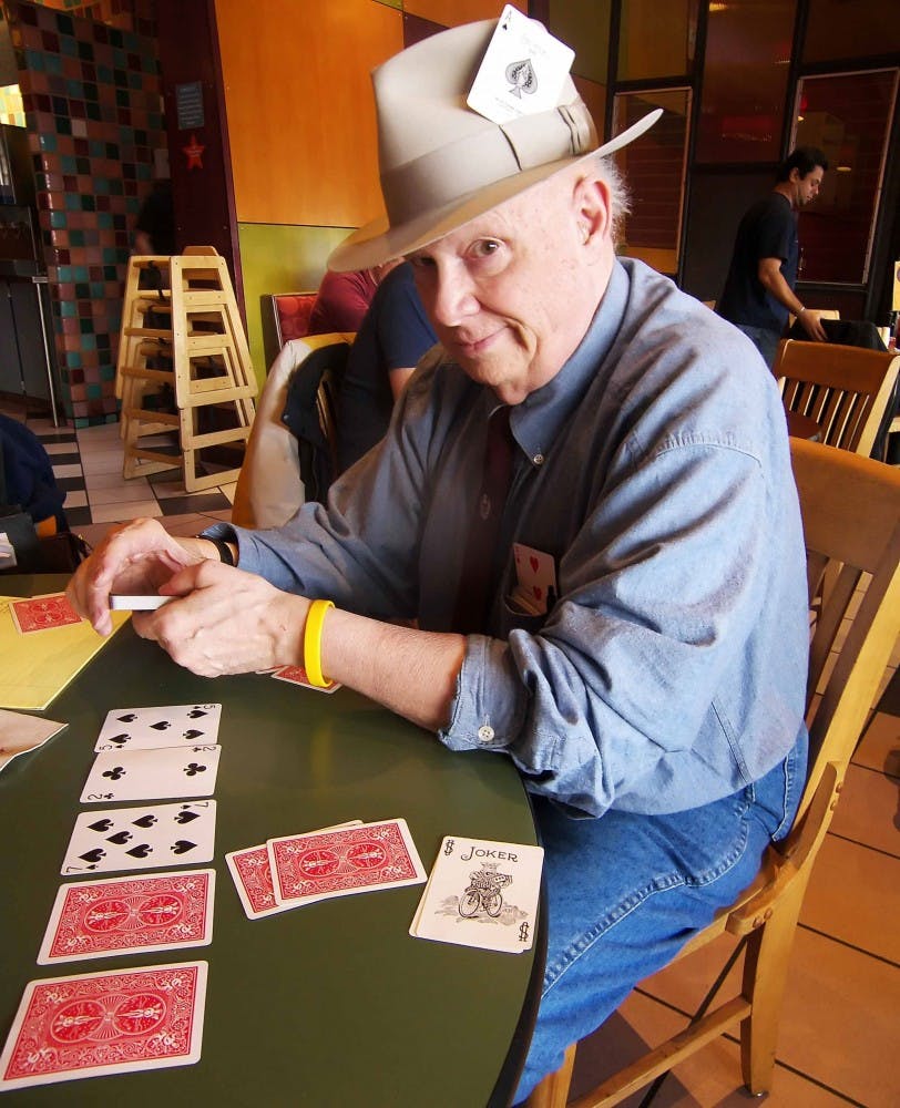 Author Dave Stewart sits at a table in Satellite Coffee at 3513 Central Ave. N.E. on Jan. 13. Stewart plays private poker games with his well-known friends.   
