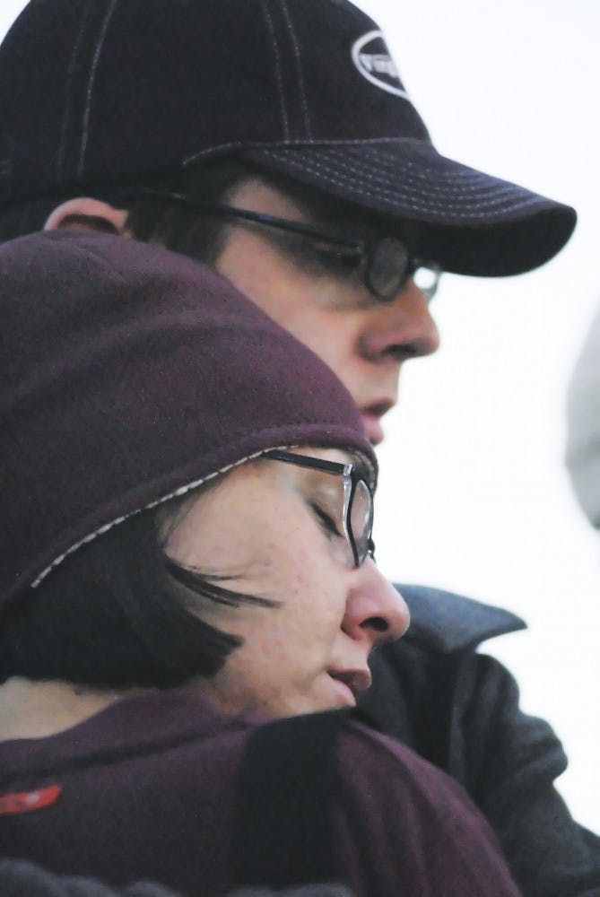 Virginia Tech graduate Jay Jones holds his girlfriend Ashley Hannold for a moment of silence during a candlelight vigil hosted by Mayor Martin Ch&aacute;vez at Civic Plaza. Hundreds of people gathered Wednesday night to remember the victims of Monday's sh