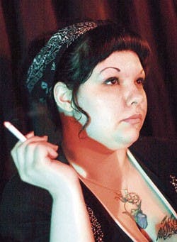 Rachel Herrera smokes a cigarette after singing a karaoke version of "Summertime" at the Atomic Cantina on Tuesday.