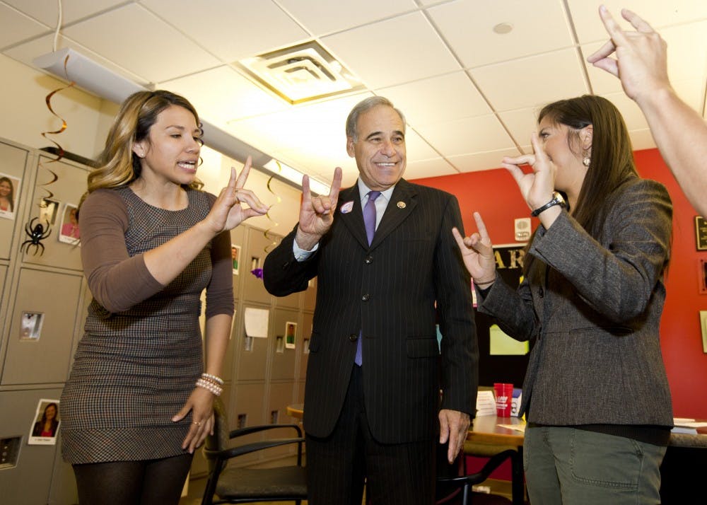 	ASUNM President Caroline Muraida (right) and ASUNM Executive Director of Governmental Affairs Cindy Nava teach Rep. Charlie Gonzalez (D-Texas) how to make the Lobo hand signal. Gonzalez visited the University to learn about student support for the DREAM Act but ended up discussing funding for education, which he said should be a priority to ensure the doors for opportunities remain open for students.