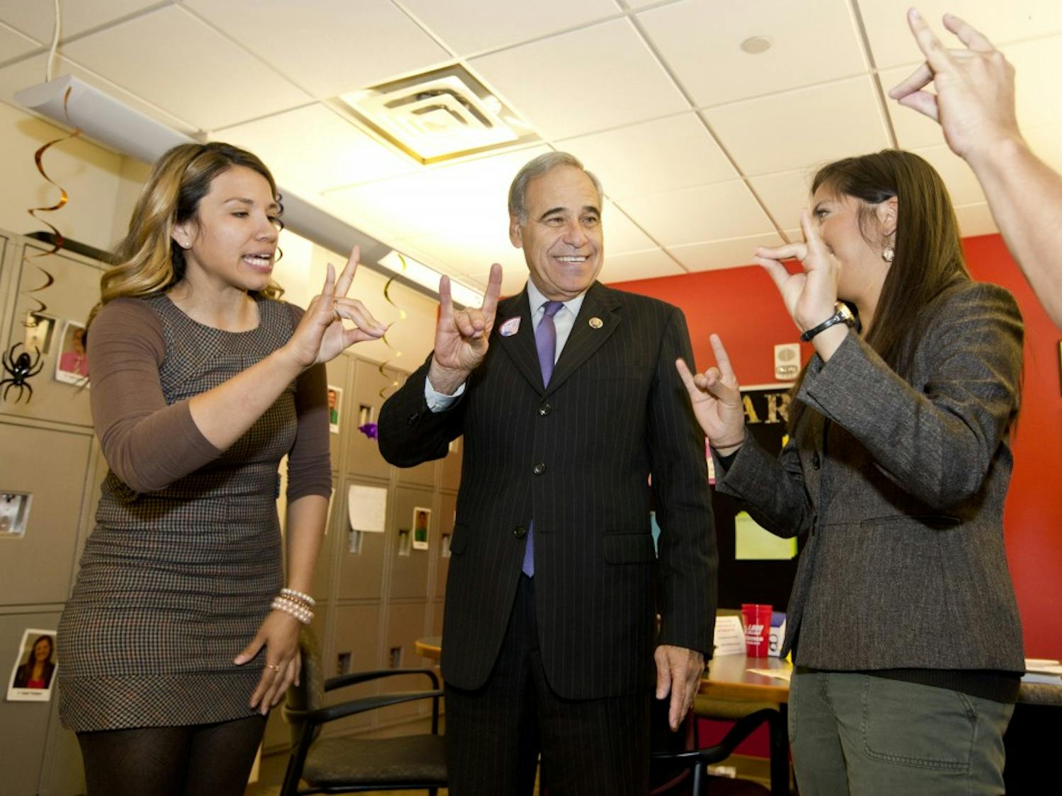 	ASUNM President Caroline Muraida (right) and ASUNM Executive Director of Governmental Affairs Cindy Nava teach Rep. Charlie Gonzalez (D-Texas) how to make the Lobo hand signal. Gonzalez visited the University to learn about student support for the DREAM Act but ended up discussing funding for education, which he said should be a priority to ensure the doors for opportunities remain open for students.