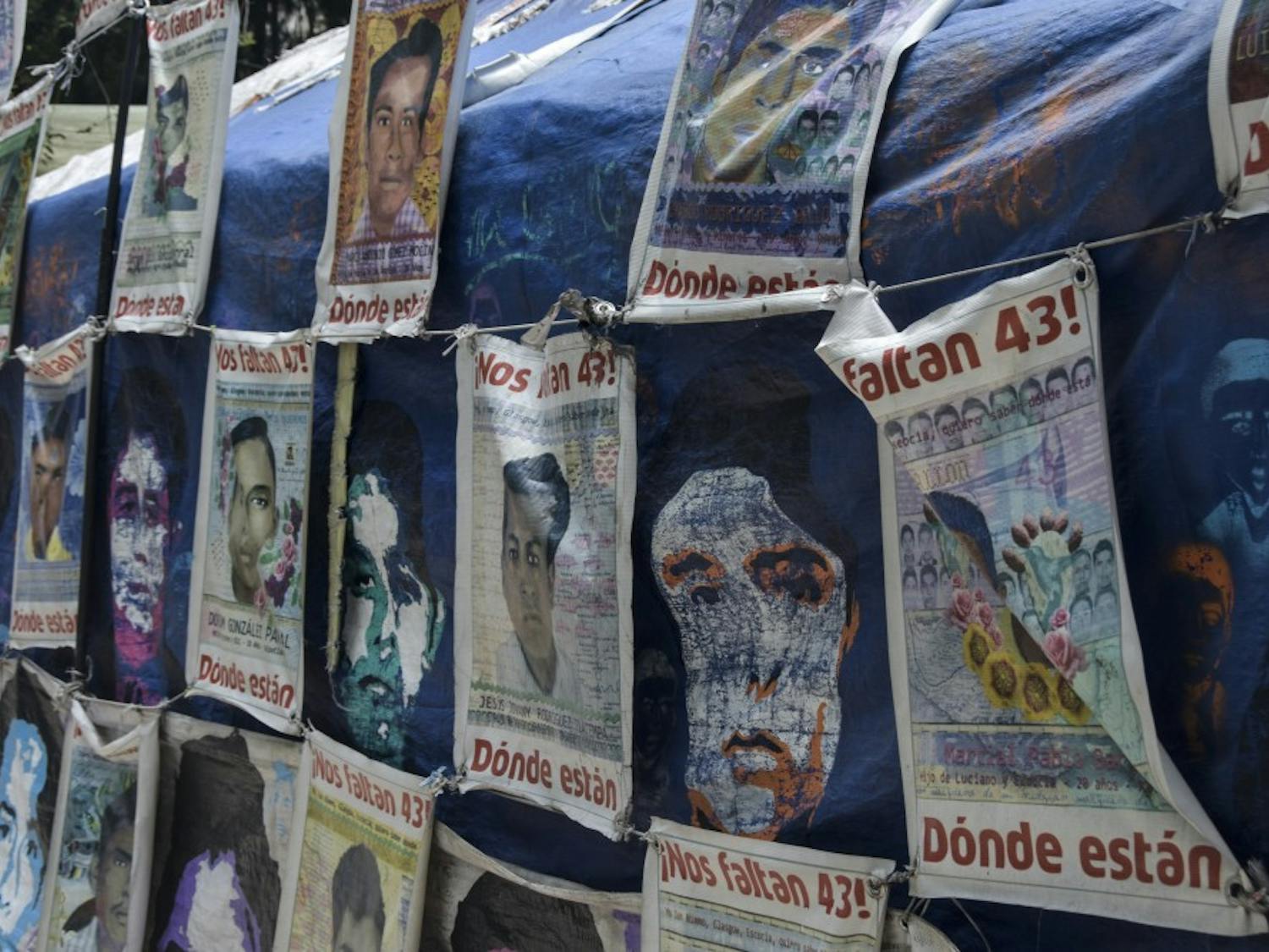Posters hang of the 43 Mexico college students that were pronounced missing July 12, 2018.