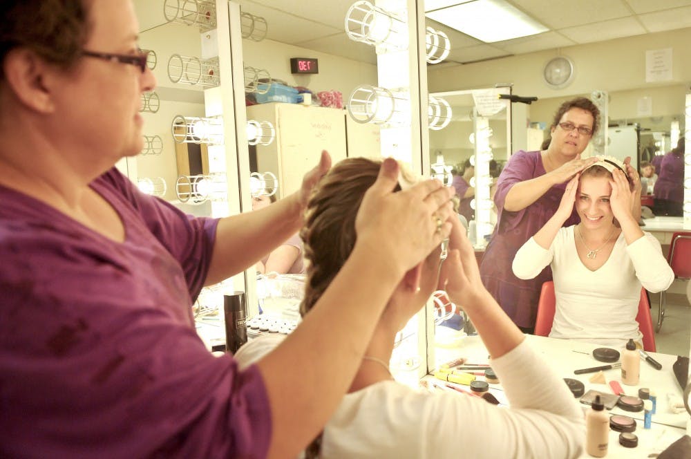 	Costume Designer Anna Avery, left prepares Kristen Buckels for her role as Anna in “Firebugs,” the first stage performance of UNM’s season. 