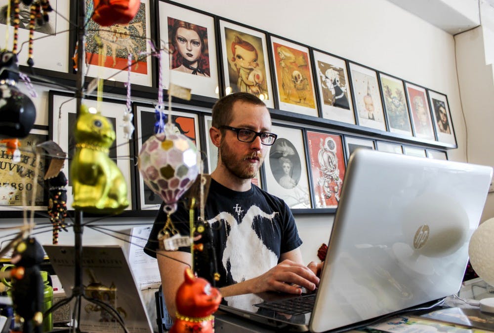 Artist Karl Deuble works on inventory Saturday afternoon at Stranger Factory. Deuble not only works at Stranger Factory but currently has a twenty piece exhibition at the shop. 