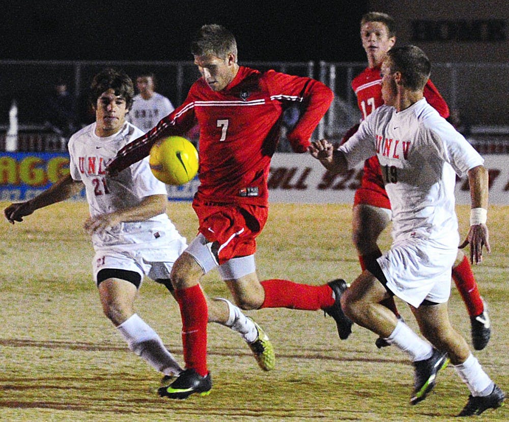 	Forward Justin Davis splits two UNLV defenders in UNM’s 2-0 win over the Rebels on Saturday at the UNM Soccer Complex. The Lobos secured the No. 2 seed and a bye in the upcoming Mountain Pacific Sports Federation Tournament.
