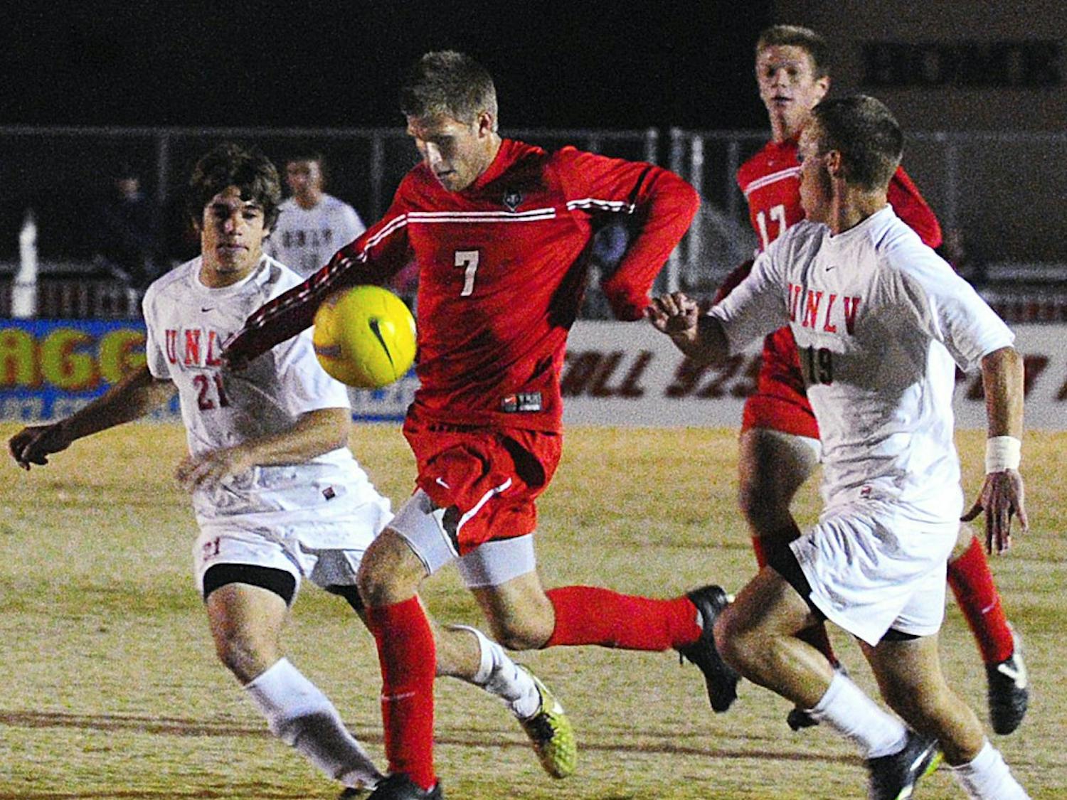 Forward Justin Davis splits two UNLV defenders in UNM’s 2-0 win over the Rebels on Saturday at the UNM Soccer Complex. The Lobos secured the No. 2 seed and a bye in the upcoming Mountain Pacific Sports Federation Tournament.
