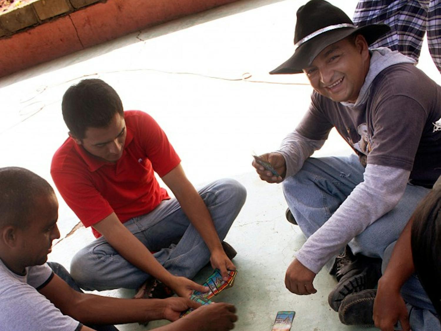 Honduran immigrants seeking refuge in Mexico play cards in a safe house in Ixtepec, Mexico, on July 16. If their refugee status is denied, they said they plan to come to America.