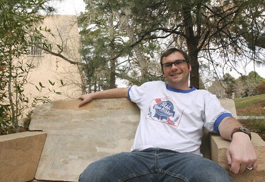 Student Andy Lilienthal, who served in the U.S. Army during the invasion of Iraq, sits by the Duck Pond on Wednesday.