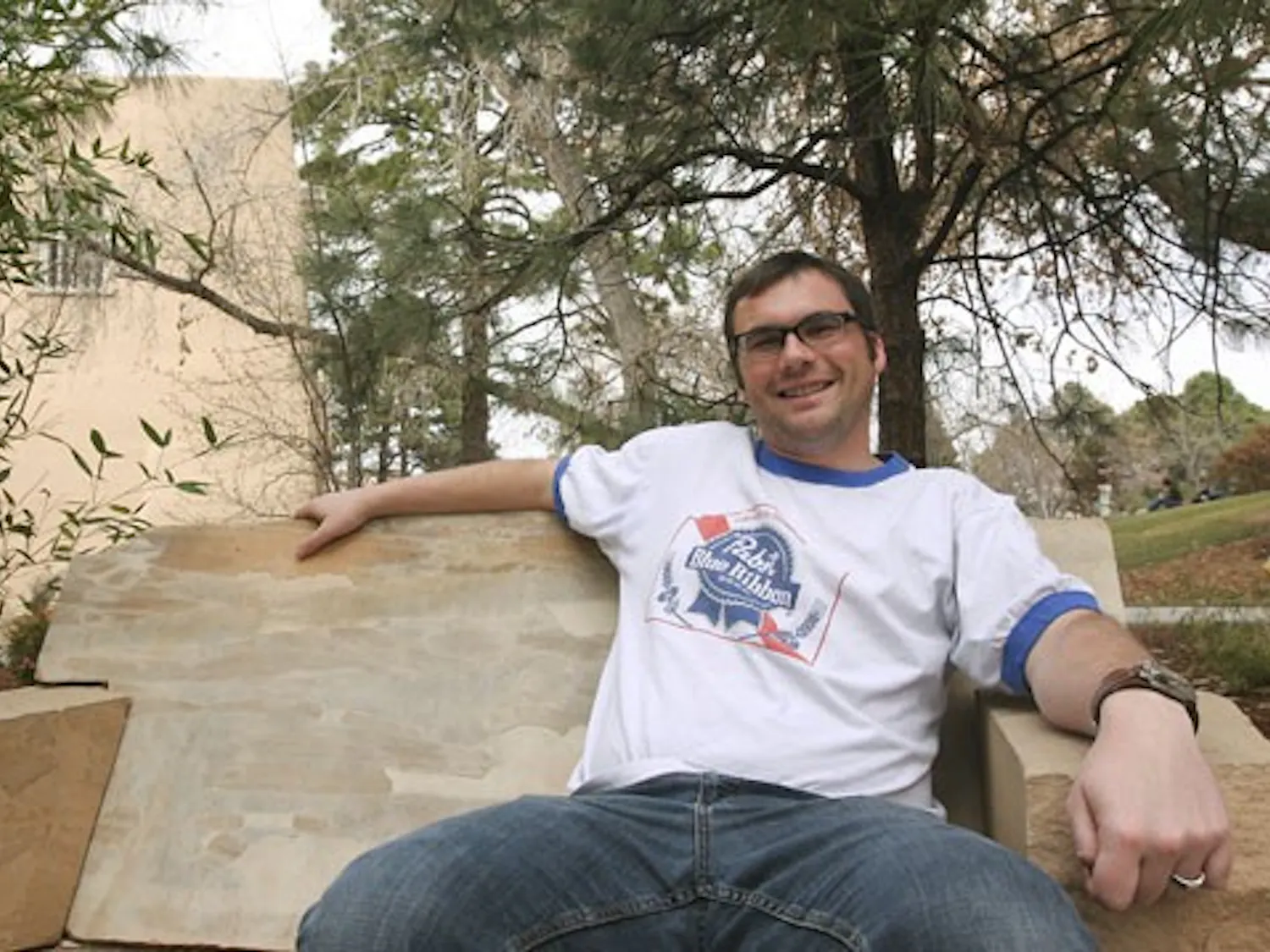 Student Andy Lilienthal, who served in the U.S. Army during the invasion of Iraq, sits by the Duck Pond on Wednesday.