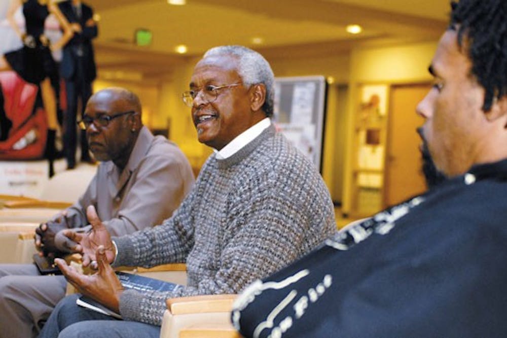 Harold Bailey, executive director of the New Mexico Office of African American Affairs, talks during a reception for a photo exhibit of the Black Panther Party at the SUB on Sunday. David Hilliard, left, who is a UNM lecturer and former chief of staff for