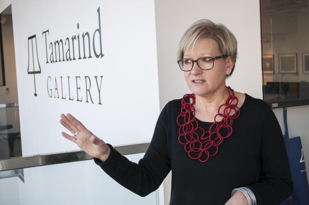 Diana Gaston, director of the Tamarind Institute, explains how things work in an art gallery Thursday morning. As the new director for the gallery, she looks forward to involving more UNM students and to bring new artists to the institute.