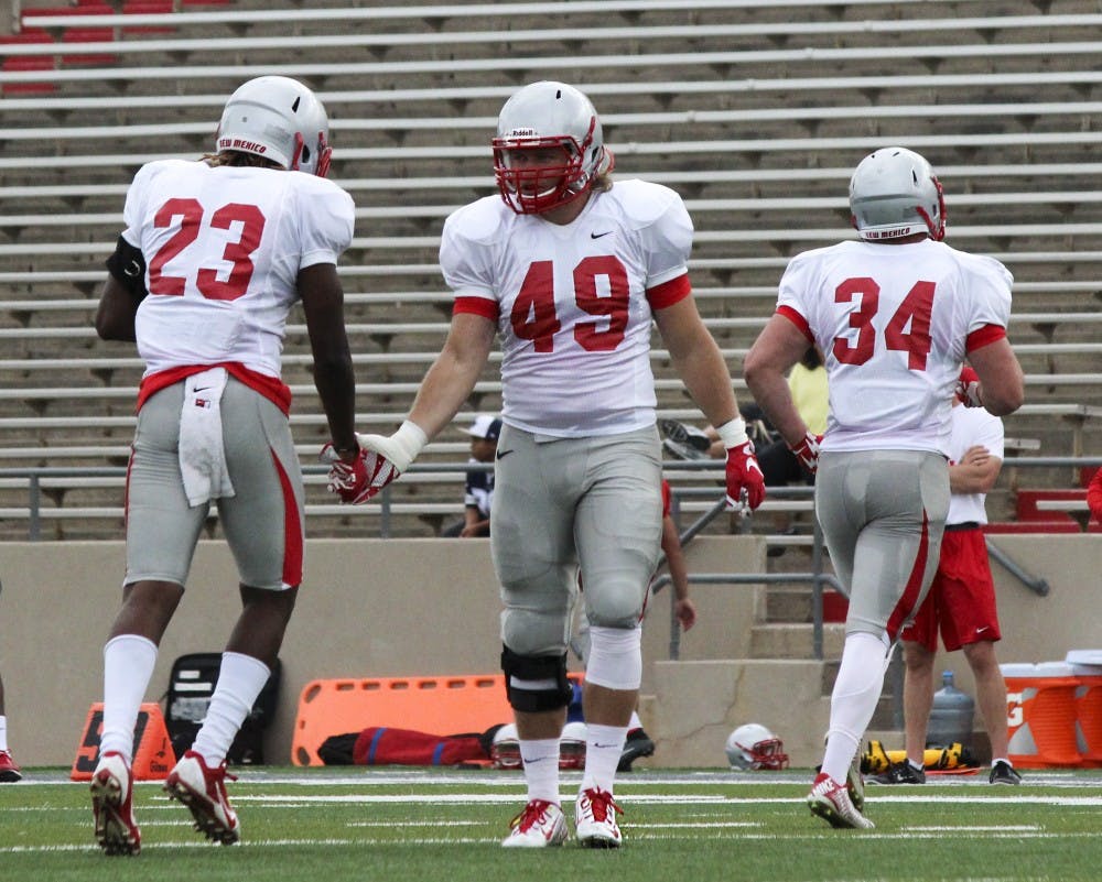 Linebacker Dakota Cox (49) checks in for a play during practice on Friday afternoon at University Stadium. Cox is returning for the 2015 football season after recovering from a torn ACL.