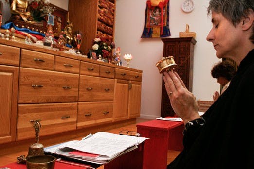 Tammy Floore, member of the RigDzin Dharma Foundation, meditates at the Tibetan Buddhist Center and Bookstore on Tuesday. UNM's SGI Buddhist club is hosting a discussion of world peace in the SUB today.
