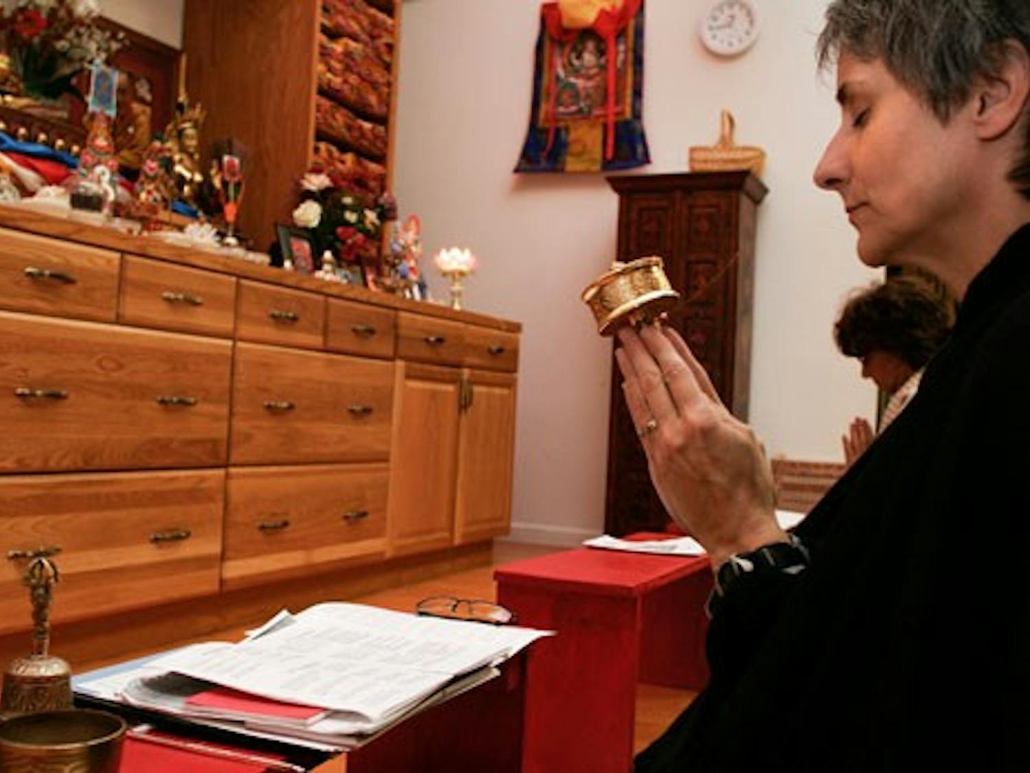 Tammy Floore, member of the RigDzin Dharma Foundation, meditates at the Tibetan Buddhist Center and Bookstore on Tuesday. UNM's SGI Buddhist club is hosting a discussion of world peace in the SUB today.