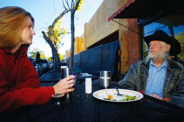 Noel Gill talks to her father, Ken, in front of Winning Coffee Co., at 111 Harvard Drive S.E., on Monday.  Construction is underway in the area to create about 7,200 square feet of retail space and 46 residential units.