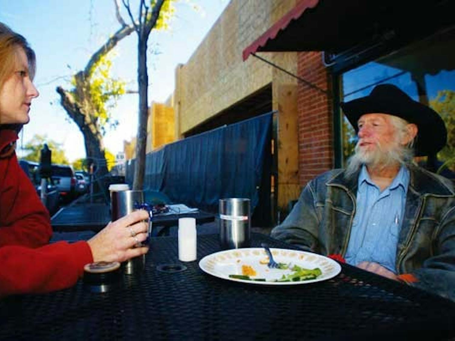 Noel Gill talks to her father, Ken, in front of Winning Coffee Co., at 111 Harvard Drive S.E., on Monday. Construction is underway in the area to create about 7,200 square feet of retail space and 46 residential units.