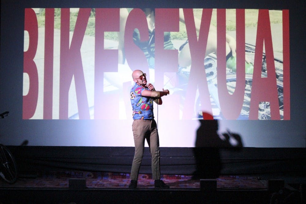 The Rev. Phil Sano, founder of Bike Smut and co-director of “Bike Porn,” addresses the crowd on Sunday night at the Guild Cinema for this year’s Pornotopia. Pornotopia is a film festival that celebrates the diversity of human sexuality and encompasses a wide variety of shows catered to all sexual fancies. 