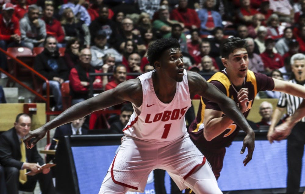 Corey Manigault guards against Iona's Ben Perez during a free throw.