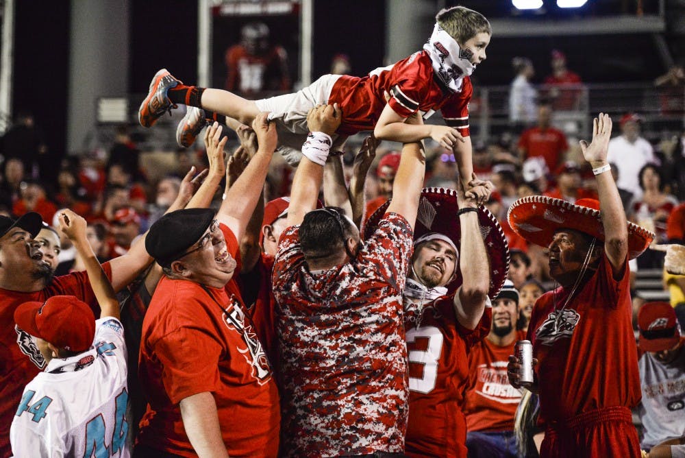 Lobo Football fans celebrate after a UNM touchdown on Thursday, Aug. 1, 2016 at University Stadium. Fans will now be able to drink up to four alcoholic beverages at select UNM sporting events.&nbsp;