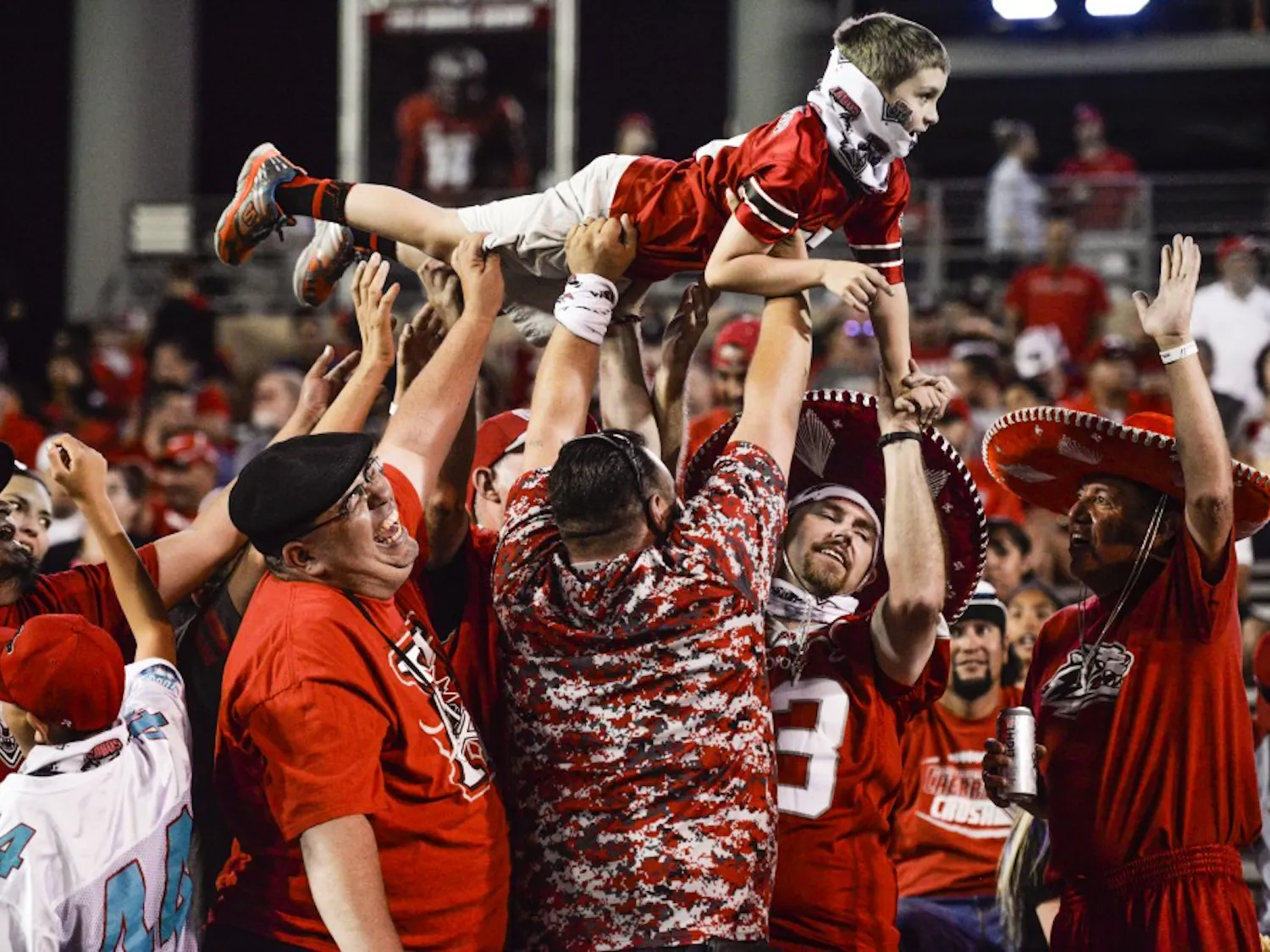 Lobo Football fans celebrate after a UNM touchdown on Thursday, Aug. 1, 2016 at University Stadium. Fans will now be able to drink up to four alcoholic beverages at select UNM sporting events. 