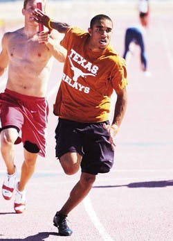 Lobo sophomore Jarrin Solomon receives the baton from Taylor Siemon during track practice at the Great Friends of UNM Track Stadium on Thursday.