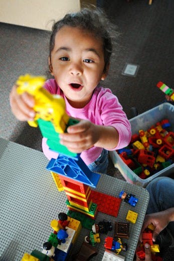 Janessah Cobley builds a Lego tower topped with a giraffe at the UNM Children's Campus on Tuesday. Expansion of the facility will soon double its capacity. 