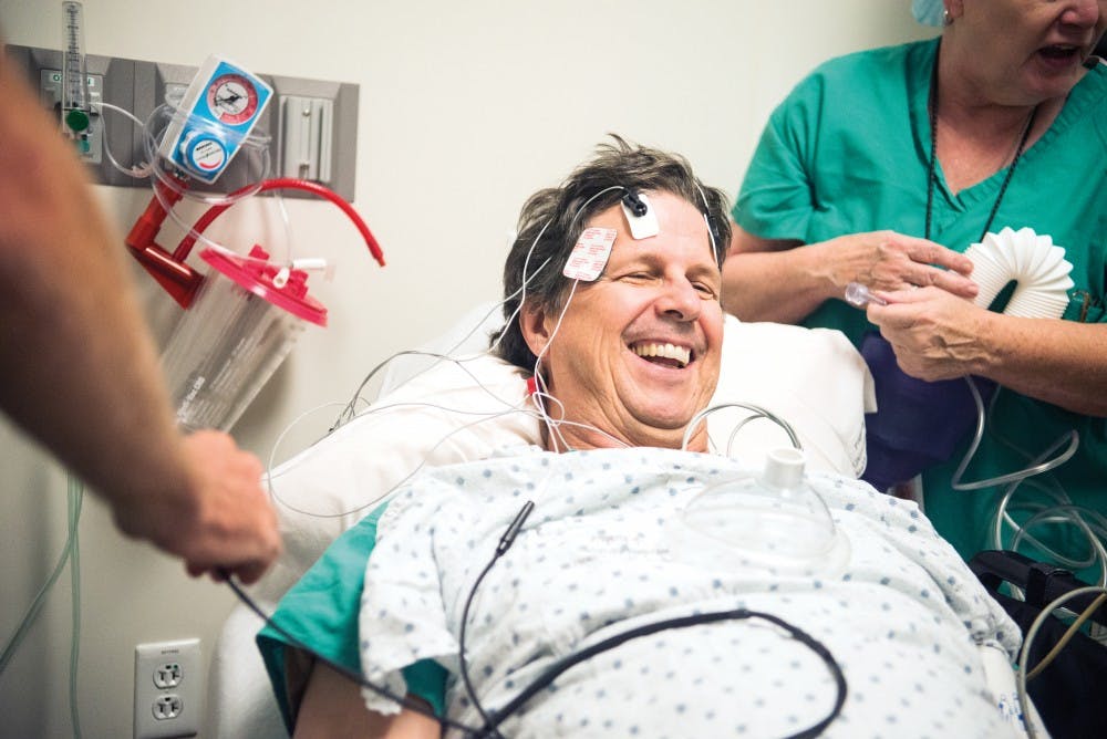 Dr. John Rask demonstrates how a team at the OSIS would prepare and administer a Electroconvulsive Therapy treatment. The team that is preparing Rask consists of Christopher Abbott, a psychiatrist; Betsy Deuble, a nurse anesthetist; and Lee Paul, an O.R. nurse.