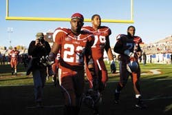 Ex-Lobos DonTrell Moore, 22, and Terrance Pennington, 79, walk off the field after the Lobos' 42-24 loss to Air Force in November at University Stadium. Pennington was drafted by the Buffalo Bills on Saturday with the 216th overall pick. 