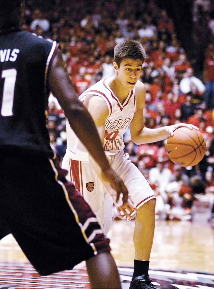 Lobo freshman Roman Martinez, a forward from El Paso, Texas, is guarded by New Mexico State guard Shaun Davis during Tuesday's 79-76 win at The Pit. UNM will travel to the University of Texas-El Paso to play the Miners on Sunday.