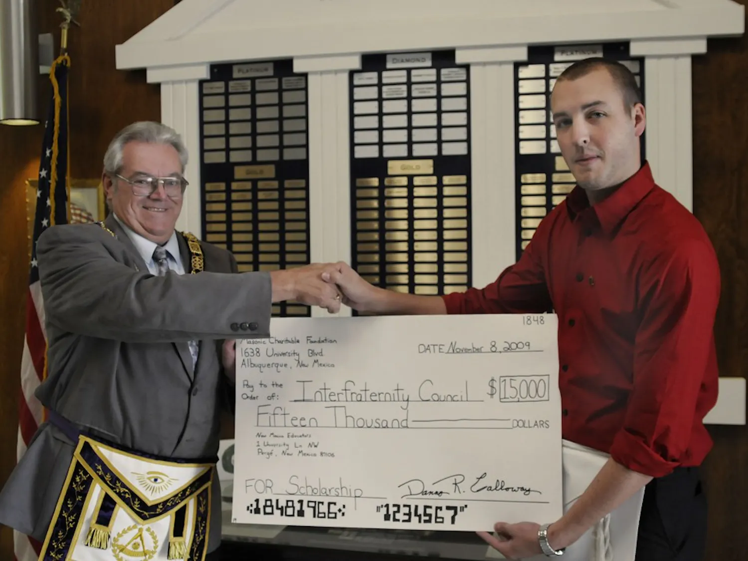 Grand Masonic Lodge Grand Secretary Danny Calloway, left, presents Interfraternity Council President Michael Westervelt with a $15,000 check at the Grand Lodge on Sunday. The money is going towards an annual $750 scholarship to fraternity members and is the first of its kind.