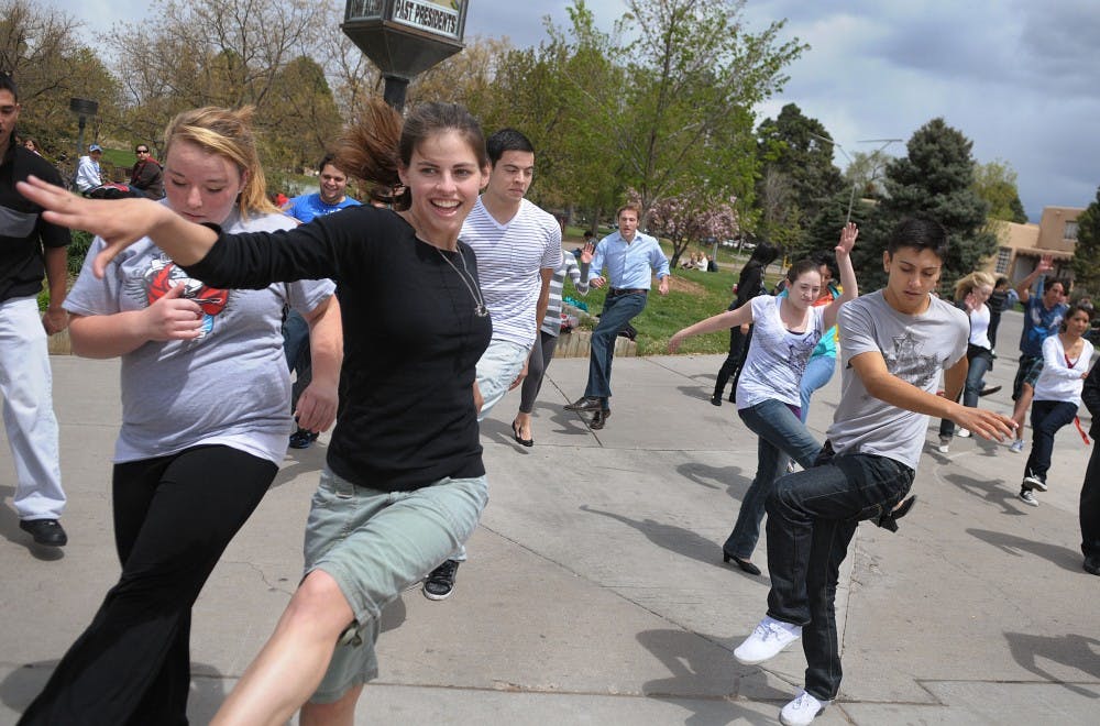 	Student Brittany Polson dances with her peers during a spontaneous routine Friday. The UNM Ballroom Dance program organized the event to promote a showcase on April 28.