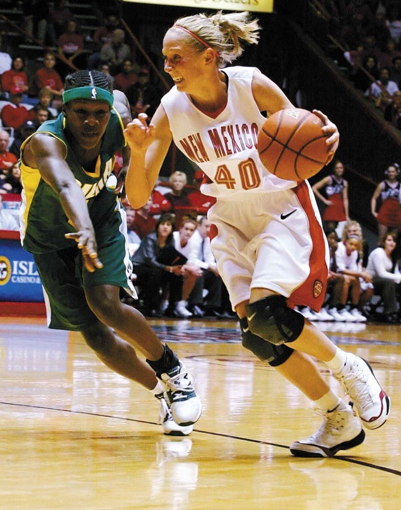 UNM guard Julie Briody drives to the basket against Siena's Shondaya Burrell during Saturday's 78-39 win at The Pit during the AmeriSuites Midtown Thanksgiving Tournament championship. The team secured its fourth Thanksgiving Tournament title.