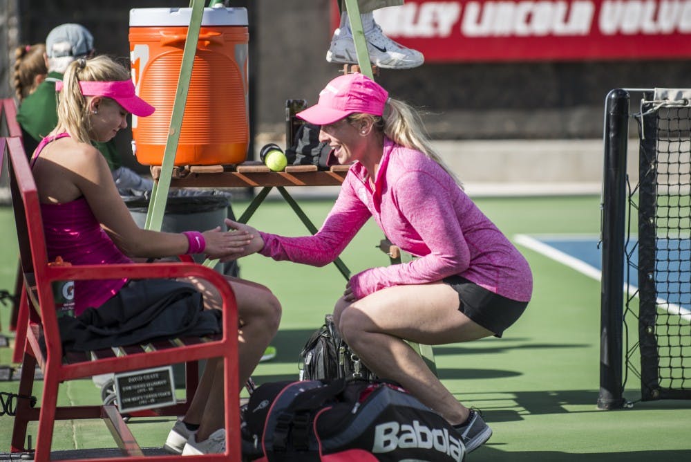 Head women's tennis coach Kelcy McKenna, left, shakes hands with Dominique Dulski during a break April 1, 2016 at the McKinnon Family Tennis Stadium. McKenna has accepted a coaching position at the University of Wisconsin.
