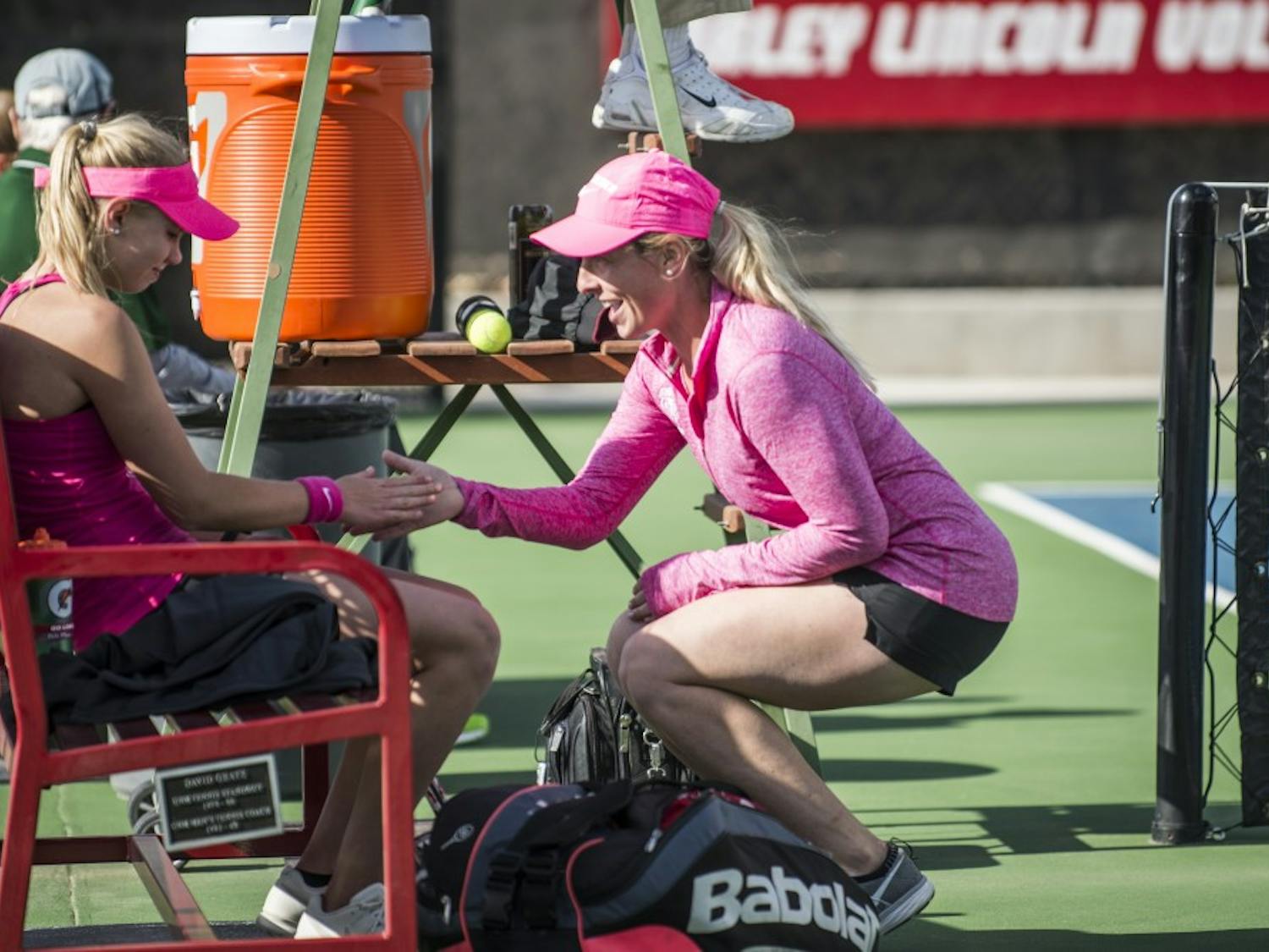 Head women's tennis coach Kelcy McKenna, left, shakes hands with Dominique Dulski during a break April 1, 2016 at the McKinnon Family Tennis Stadium. McKenna has accepted a coaching position at the University of Wisconsin.