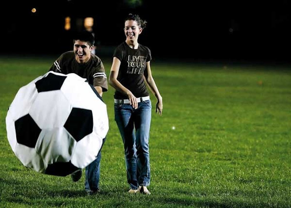 Nick Torres and Morgan Swinehart hit a giant soccer ball during Recreational Services' 50th Anniversary Birthday Bash on Tuesday at Johnson Field.