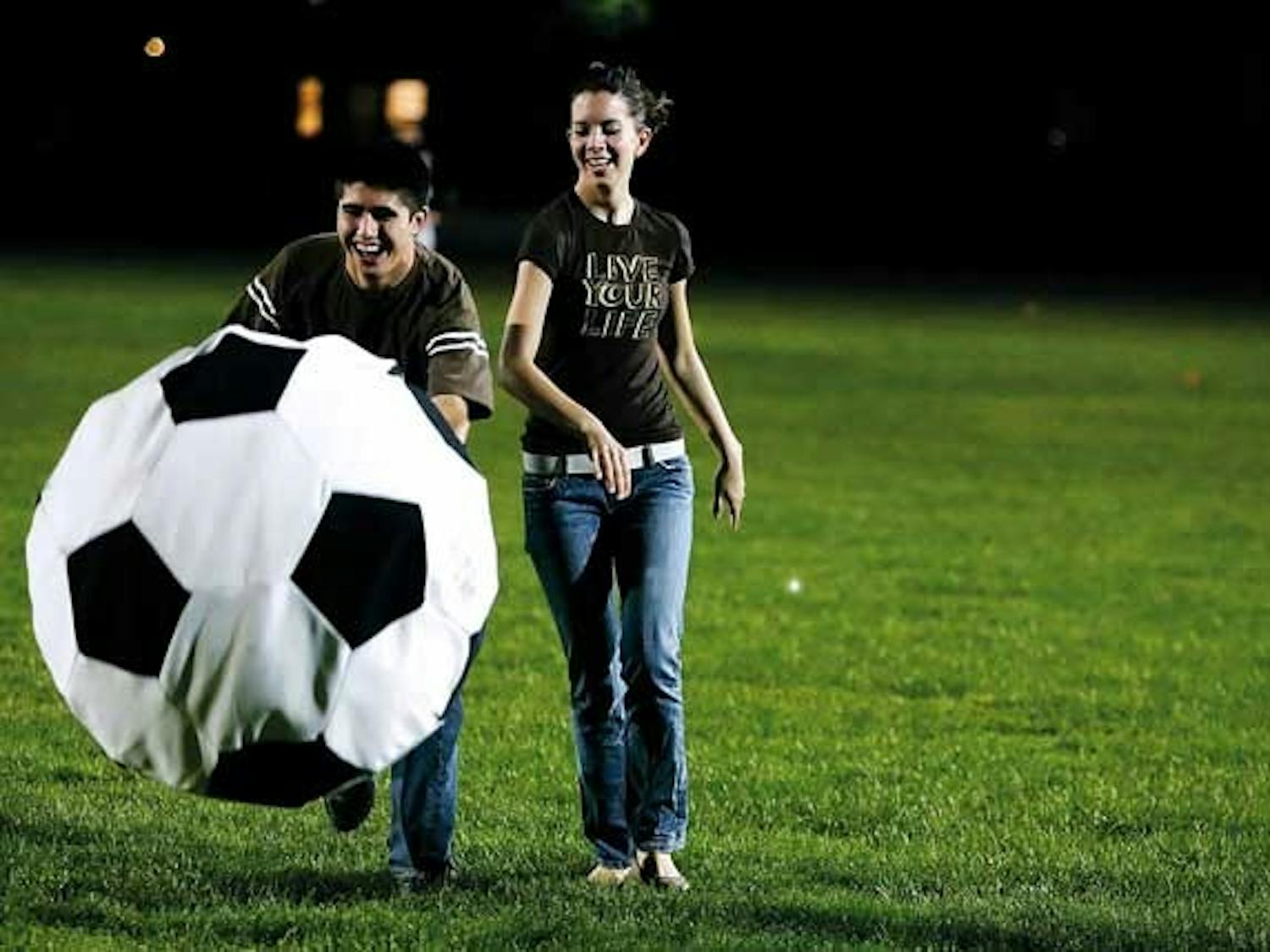 Nick Torres and Morgan Swinehart hit a giant soccer ball during Recreational Services' 50th Anniversary Birthday Bash on Tuesday at Johnson Field.