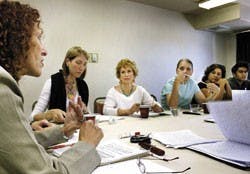 Anya Achtenberg, left, critiques a student's work during an afternoon workshop at the Sagebrush Hotel for the Taos Summer Writers' Conference held last week.