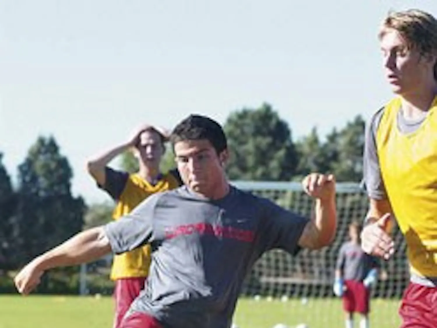 UNM midfielder Bryan Sajjadi, left, takes a shot on goal while defender Simon Ejdemyr plays defense in a scrimmage game during practice at Robertson Field on Aug. 10.