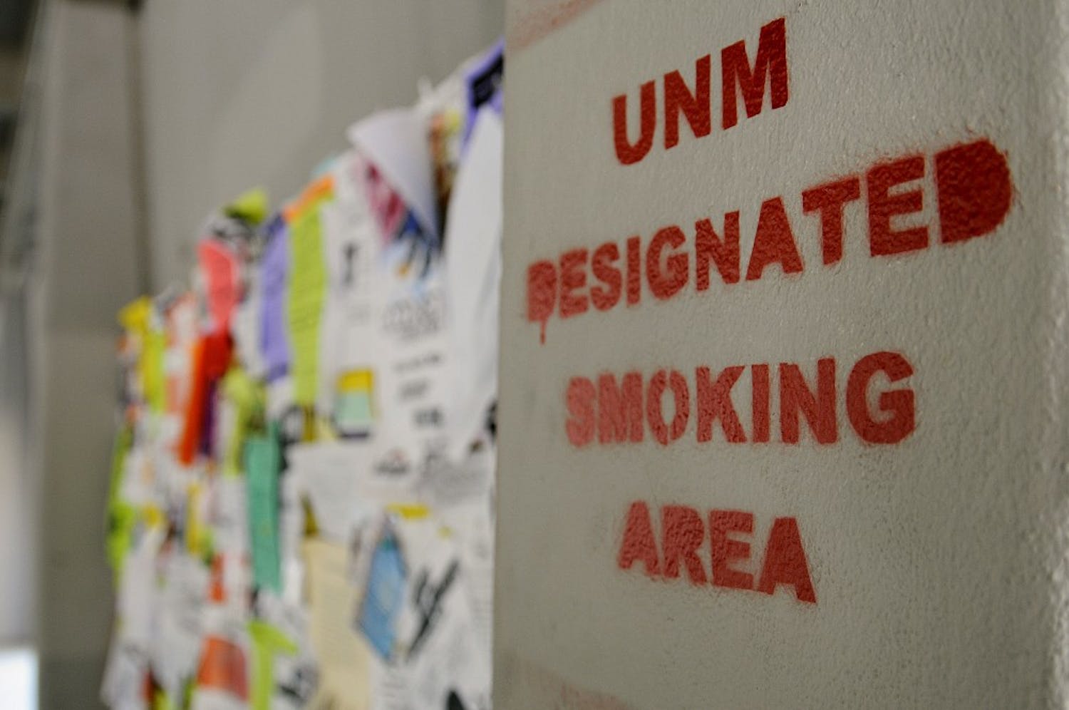 	A spray-painted sign near Ortega Hall falsely designates a smoking area. The Physical Plant Department has removed more than 60 similar graffiti signs.