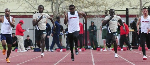 UNM's Jermaine McQueen, center, sprints toward the finish line in the 100-meter dash. McQueen, who ran in two events on Saturday, placed second in both.  