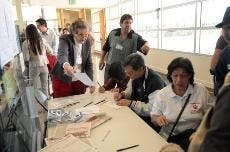 Ann Workman, left, oversees voters filling out ballot applications in the SUB on Tuesday. 
