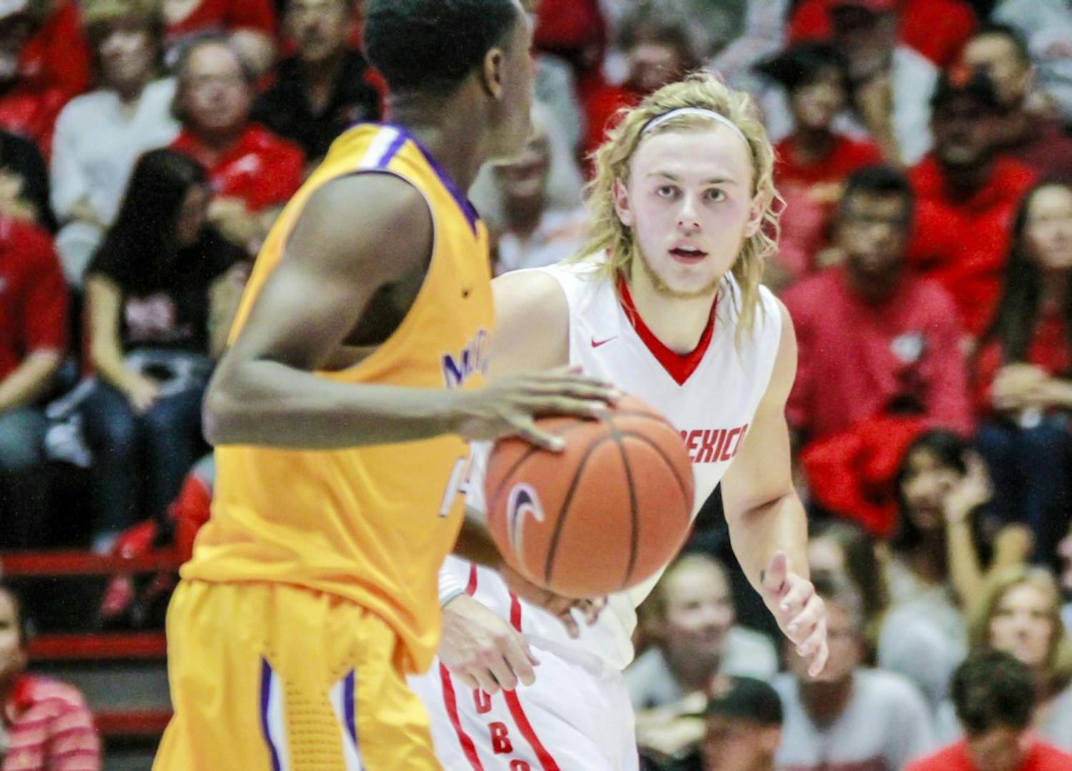 UNMís Hugh Greenwood, right, defends Western New Mexicoís Brandon Williams, left, as he looks for an open teammate to pass to during their game Saturday in the Pit.