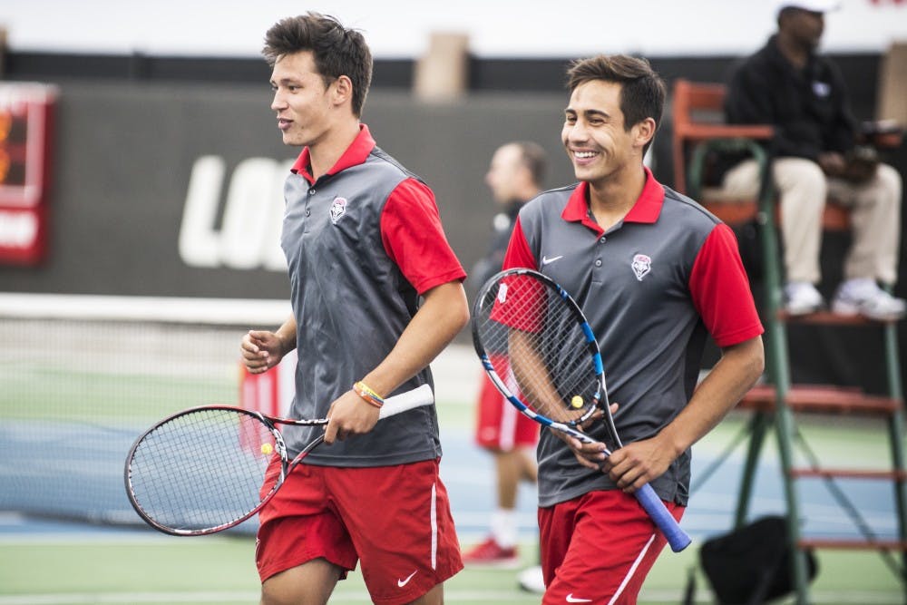 Freshman Ricky Hernandez-Tong (left) and sophomore Jorge Escutia walk of the court after finishing a doubles match April 17, 2016 at the McKinnon Family Tennis Stadium.&nbsp;