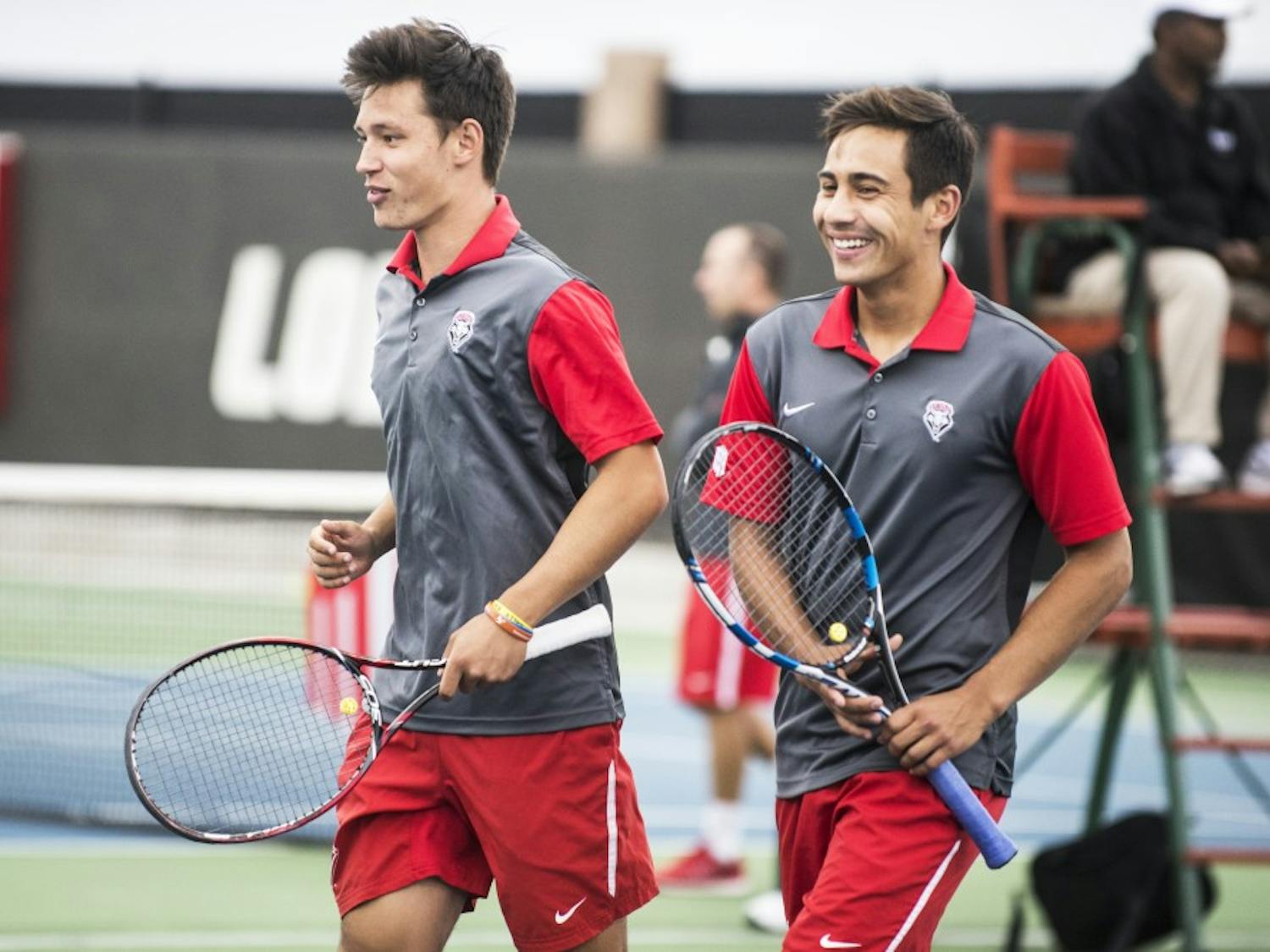 Freshman Ricky Hernandez-Tong (left) and sophomore Jorge Escutia walk of the court after finishing a doubles match April 17, 2016 at the McKinnon Family Tennis Stadium.&nbsp;