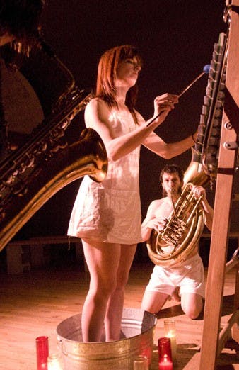 Sandy Timmerman plays a xylophone while Richard Van Schouwen plays a sousaphone in "Snake Oil for the Love Lorn" at the q-Staff Theater.
