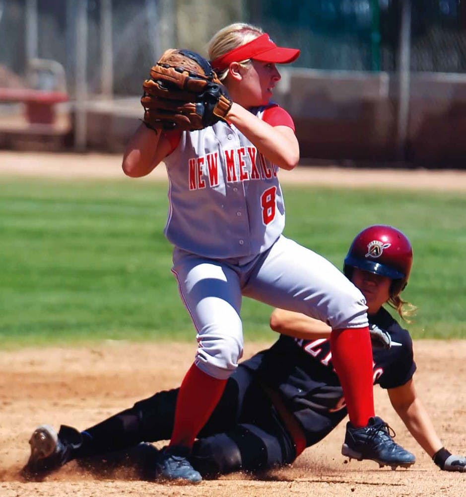 UNM's Amy Ray throws to first base after tagging out San Diego State's Monica Alnes during Sunday's game at Lobo Field. The Lobos won 6-4. 