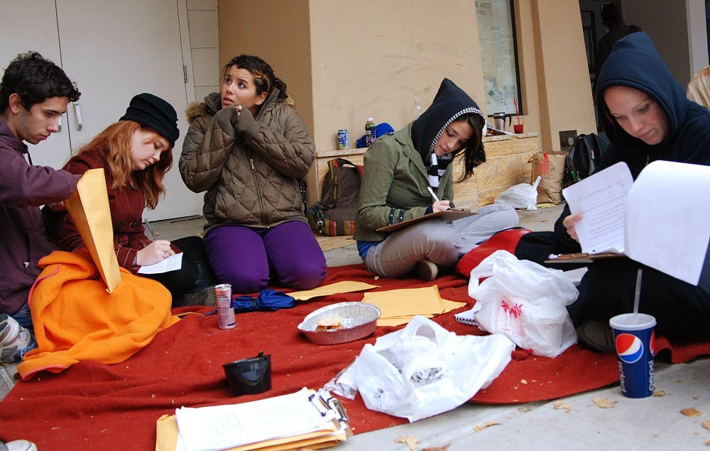 	From left, students Ian Alden, Amy Bourque, Rachel Leos, Laura Hosen and Tara Brown sit outside Popejoy Hall to gather signatures for a petition expressing problems with the theater department. Students from the department protested their concerns Wednesday.